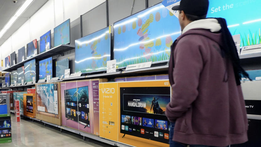 HALLANDALE BEACH, FLORIDA - FEBRUARY 20: A customer walks past televisions, including the Vizio brand, on display in a Walmart Supercenter on February 20, 2024, in Hallandale Beach, Florida. Walmart reported that quarterly revenue rose 6%, and that the company’s global e-commerce sales have also grown. Walmart also said that it agreed to purchase TV maker Vizio for $2.3 billion. (Photo by Joe Raedle/Getty Images)