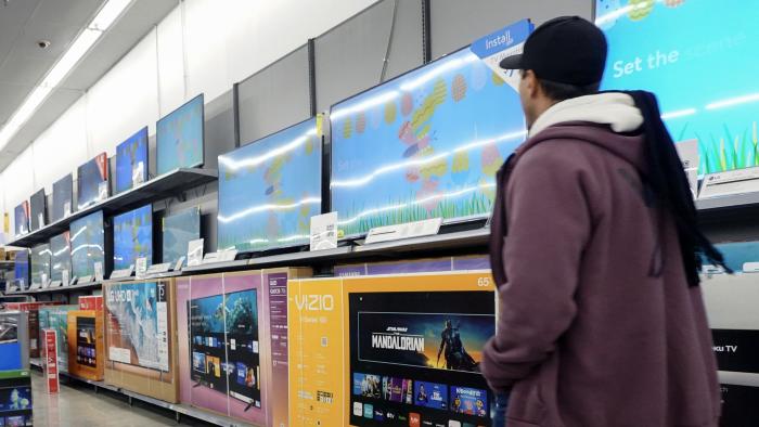 HALLANDALE BEACH, FLORIDA - FEBRUARY 20: A customer walks past televisions, including the Vizio brand, on display in a Walmart Supercenter on February 20, 2024, in Hallandale Beach, Florida. Walmart reported that quarterly revenue rose 6%, and that the company’s global e-commerce sales have also grown. Walmart also said that it agreed to purchase TV maker Vizio for $2.3 billion. (Photo by Joe Raedle/Getty Images)