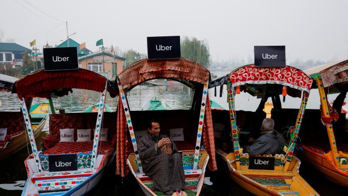 Uber signs are displayed on "Shikaras" or small boats after Uber launched its first water transport service on the waters of Dal Lake, one of Kashmir's main tourist attractions, in Srinagar, December 2, 2024. REUTERS/Sharafat Ali