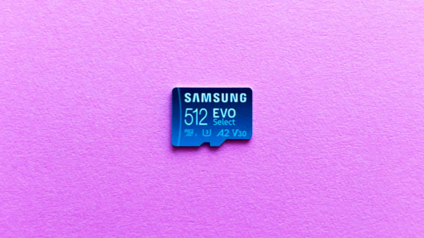 A light blue microSD card, the Samsung Evo Select, rest against a pink background.  