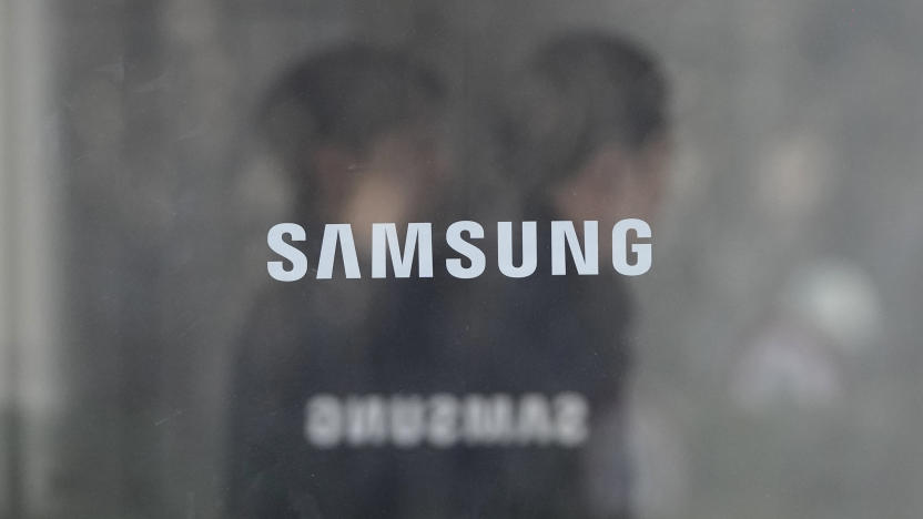 Employees walk past logos of the Samsung Electronics Co. at its office in Seoul, South Korea, Wednesday, Jan. 31, 2024. Samsung Electronics on Wednesday reported an annual 34% decline in operating profit for the last quarter as sluggish demands for its TVs and other consumer electronics products offset hard-won gains from a slowly recovering computer chip market. (AP Photo/Ahn Young-joon)