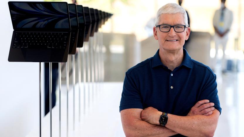 Apple CEO Tim Cook poses for a portrait next to a line of new MacBook Airs as he enters the Steve Jobs Theater during the Apple Worldwide Developers Conference (WWDC) at the Apple Park campus in Cupertino, California on June 6, 2022 . (Photo by Chris Tuite / AFP) (Photo by CHRIS TUITE/AFP via Getty Images)