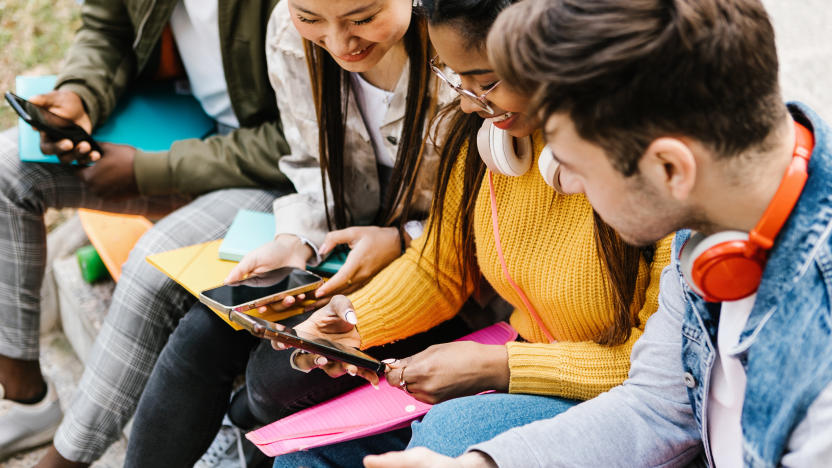 Diverse young teenage students having fun using mobile phone in college campus - Education, millennial people and social media concept