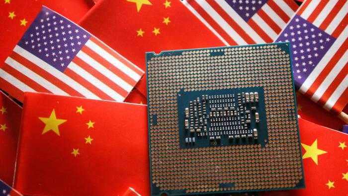 FILE PHOTO: A central processing unit (CPU) semiconductor chip is displayed among flags of China and U.S., in this illustration picture taken February 17, 2023. REUTERS/Florence Lo/Illustration/File Photo