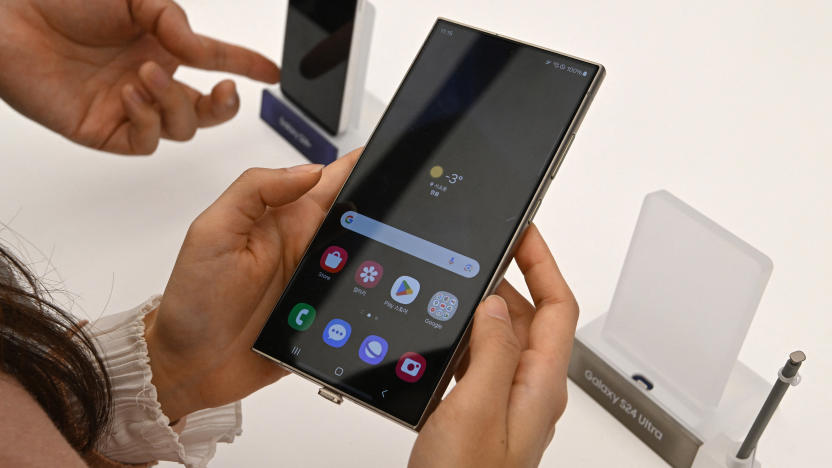 This picture taken on January 15, 2024 shows a woman looking at a Samsung Galaxy S24 Ultra smartphone displayed during a media preview event at a Samsung store in Seoul. (Photo by Jung Yeon-je / AFP) (Photo by JUNG YEON-JE/AFP via Getty Images)