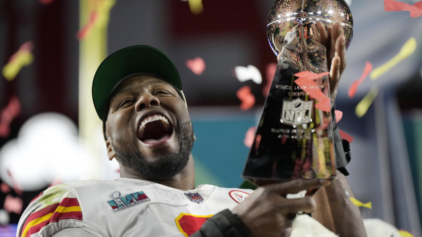 Kansas City Chiefs defensive end Carlos Dunlap celebrates with the Vince Lombardi Trophy after the NFL Super Bowl 57 football game, Sunday, Feb. 12, 2023, in Glendale, Ariz. The Kansas City Chiefs defeated the Philadelphia Eagles 38-35. (AP Photo/Ashley Landis)